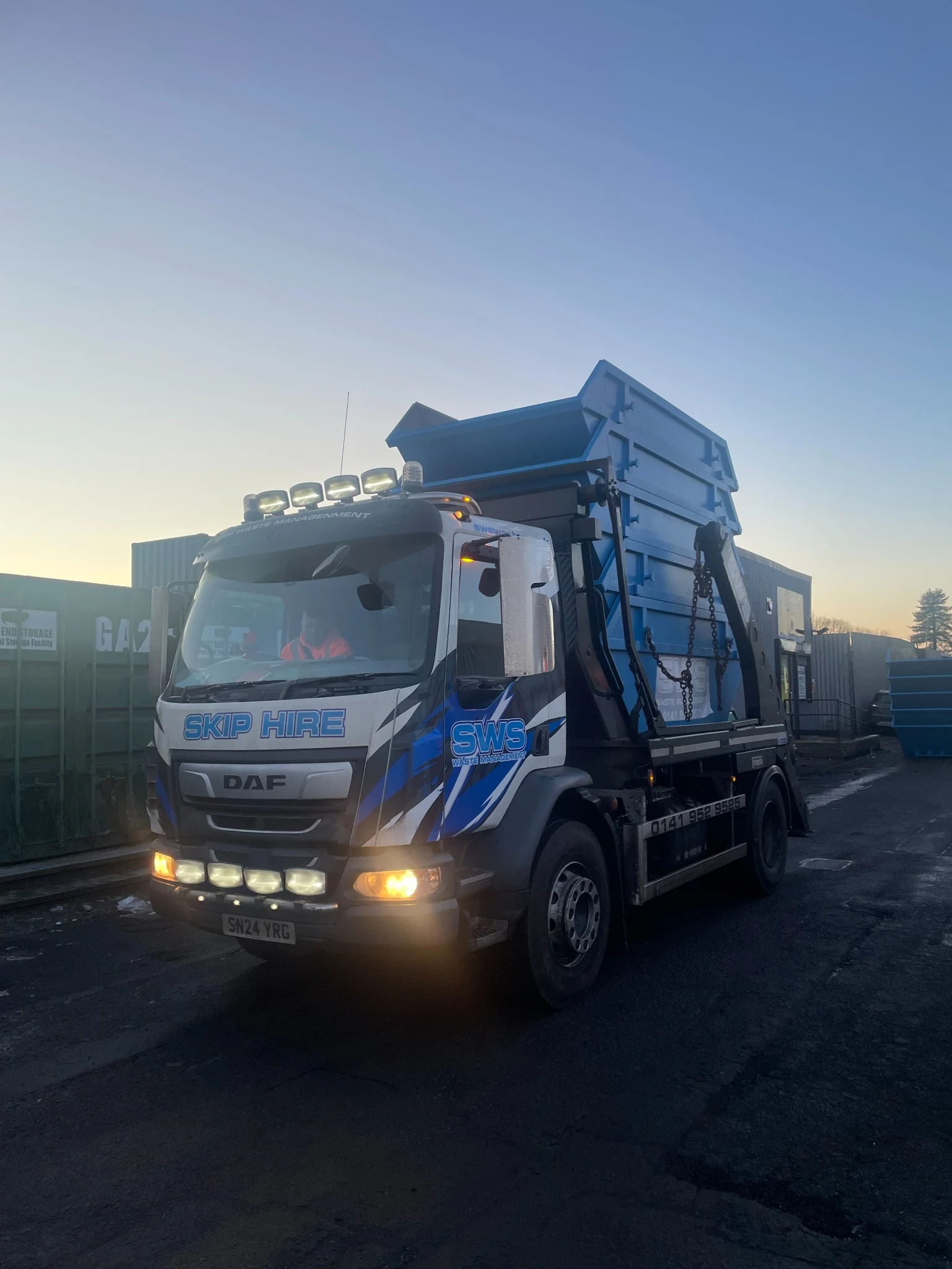 SWS skip lorry with large blue skip container