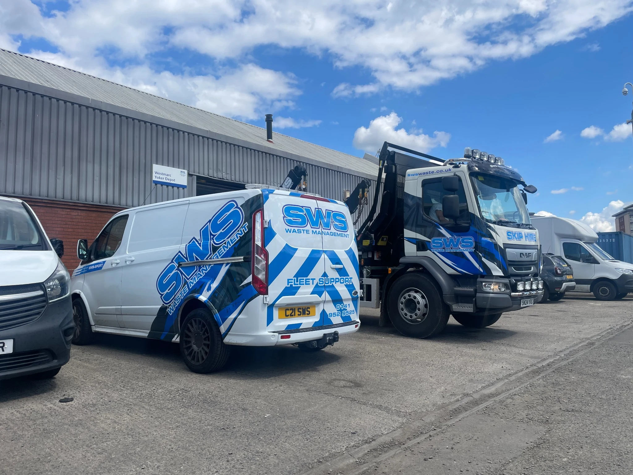 SWS branded uplift van and skip lorry at the yard